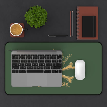 Blessed Loser Desk Mat — Crown & Crossbones Green Gaming/Office Mouse Pad on a workspace with laptop and coffee.