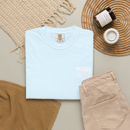 Blessed Loser T-Shirt — Vintage Samurai Triangle Back Print folded next to neutral accessories on a flat surface.