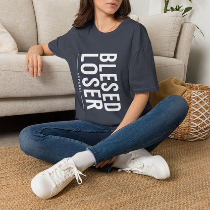 Model wearing a Blessed Loser T-Shirt | Vertical Bold Text Graphic Tee, sitting on the floor in casual style.