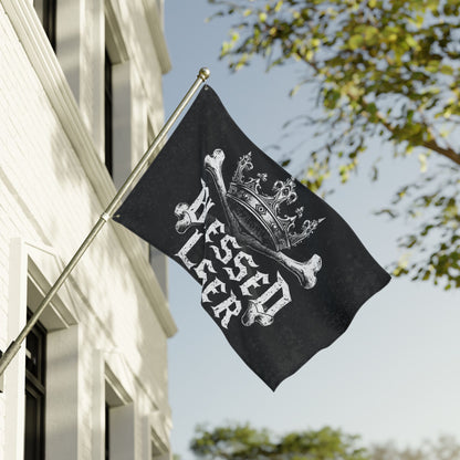 Blessed loser Black flag flying prominently outside, featuring unique design with crown and crossed bones.