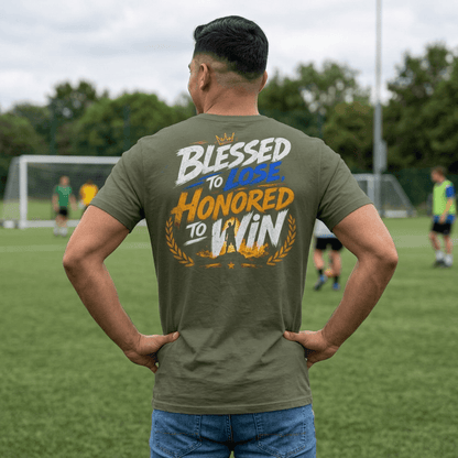 Man wearing a Military Green Blessed to Lose, Honored to Win T-Shirt on a field, showcasing the back graphic.
