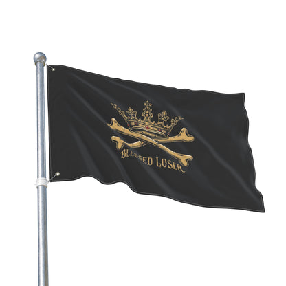 Double-Sided Blessed loser pirate flag waving on a pole with a black background and gold design elements.