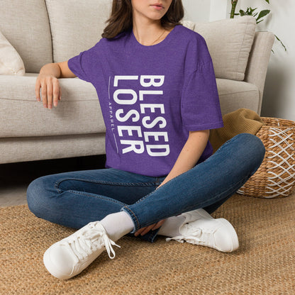 Model wearing a Blessed Loser T-Shirt | Vertical Bold Text Graphic Tee, sitting on the floor in a cozy living room.