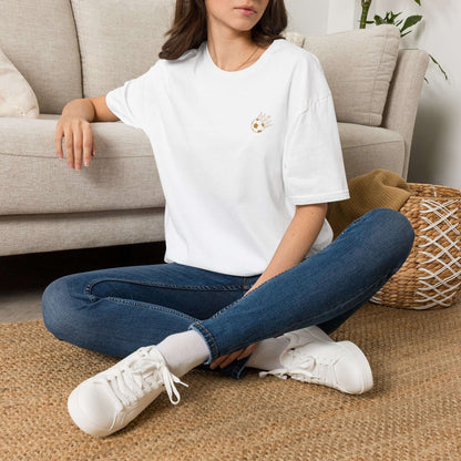 Cute Crowned Cat Pocket Tee — Minimal Embroidered Kitten T-Shirt model sitting casually on a sofa